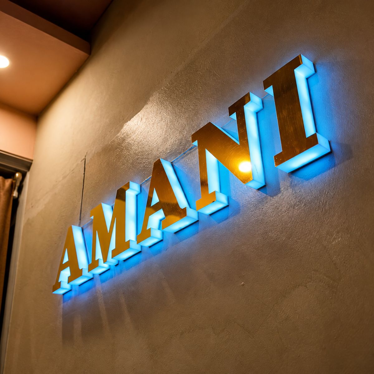 Amani signage lit at night